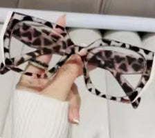 Pair of leopard print bow shoes on a white background