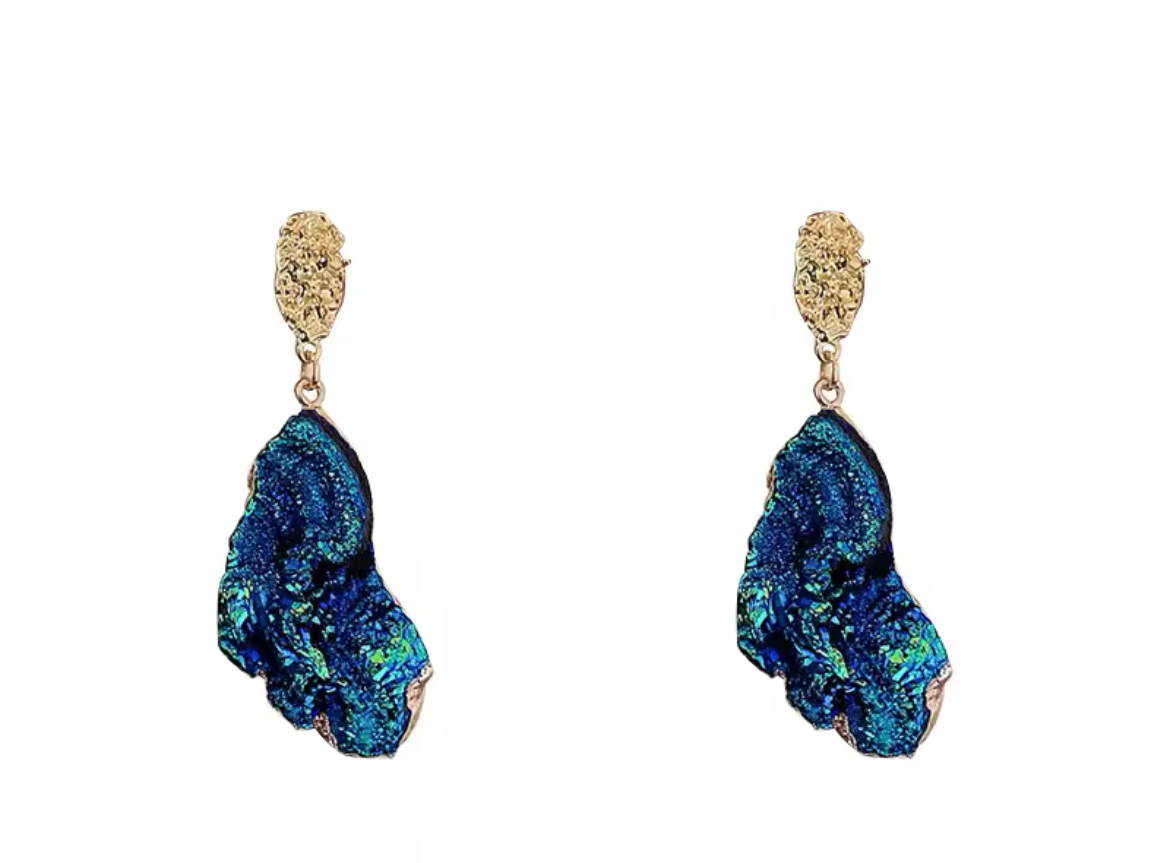 Pair of blue earrings with gold accents on a white background