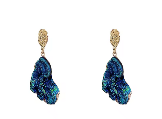 Pair of blue earrings with gold accents on a white background