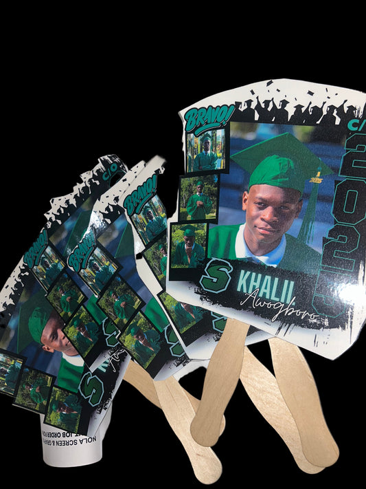 Stack of promotional posters with a person's face on them, placed on a surface.